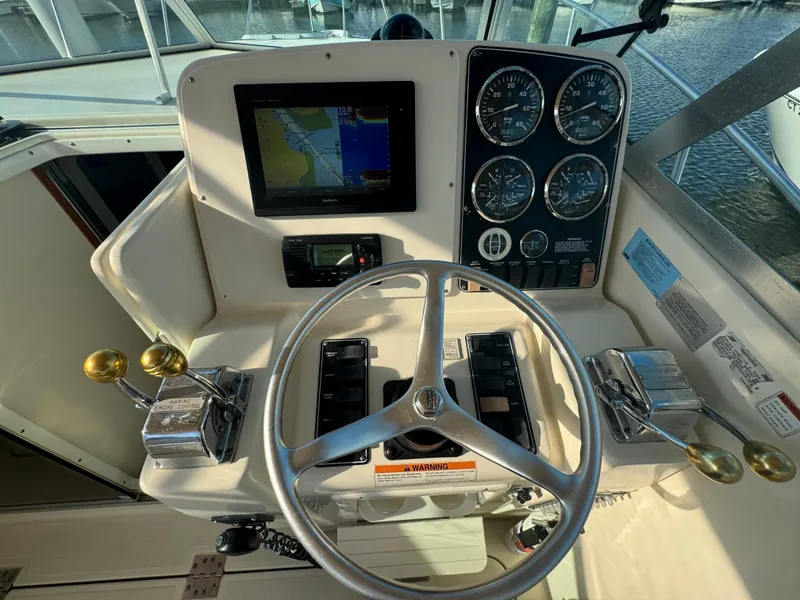 Slide: The Image of 2001 Pursuit 3000 Express helm with steering wheel, gauges, and navigation display. - 5