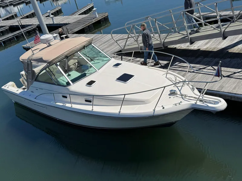 Slide: The Image of 2001 Pursuit 3000 Express boat docked at marina with person on pier. - 8