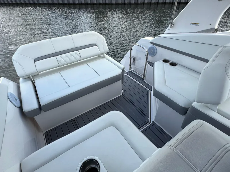 Slide: The Image of 2024 Regal 26 XO boat interior with white seating and water view. - 11