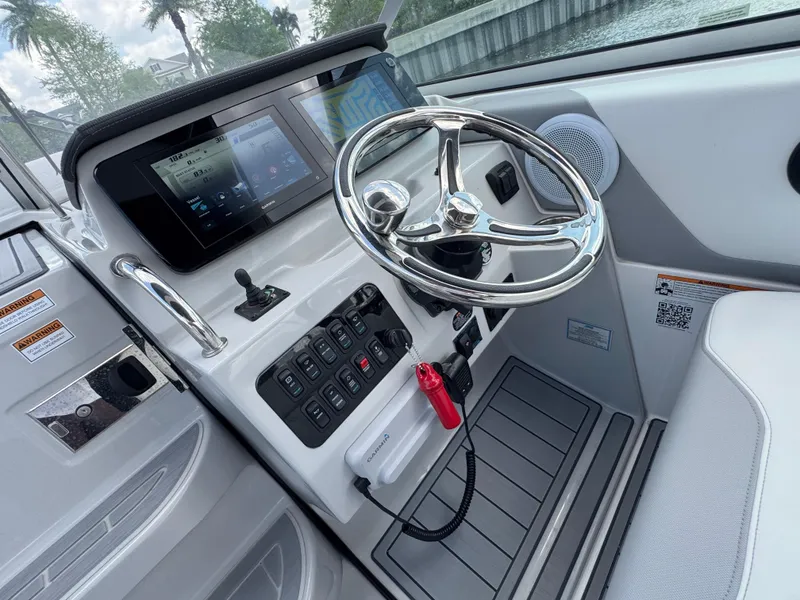 Slide: The Image of 2024 Regal 26 XO boat helm with modern controls and sleek steering wheel. - 19