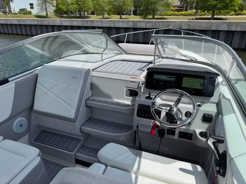 Slide: The Image of 2024 Regal 26 XO boat interior with modern dashboard and steering wheel. - 21
