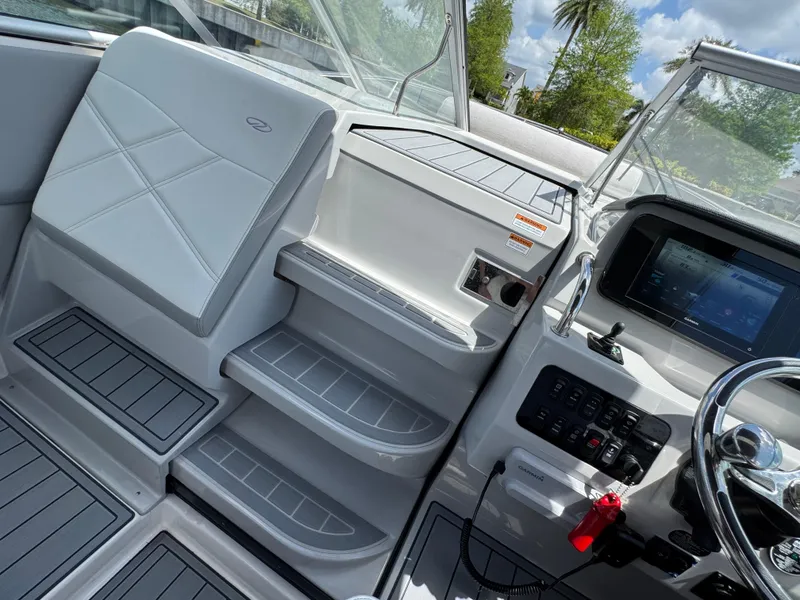 Slide: The Image of 2024 Regal 26 XO boat interior with modern dashboard and seating. - 22