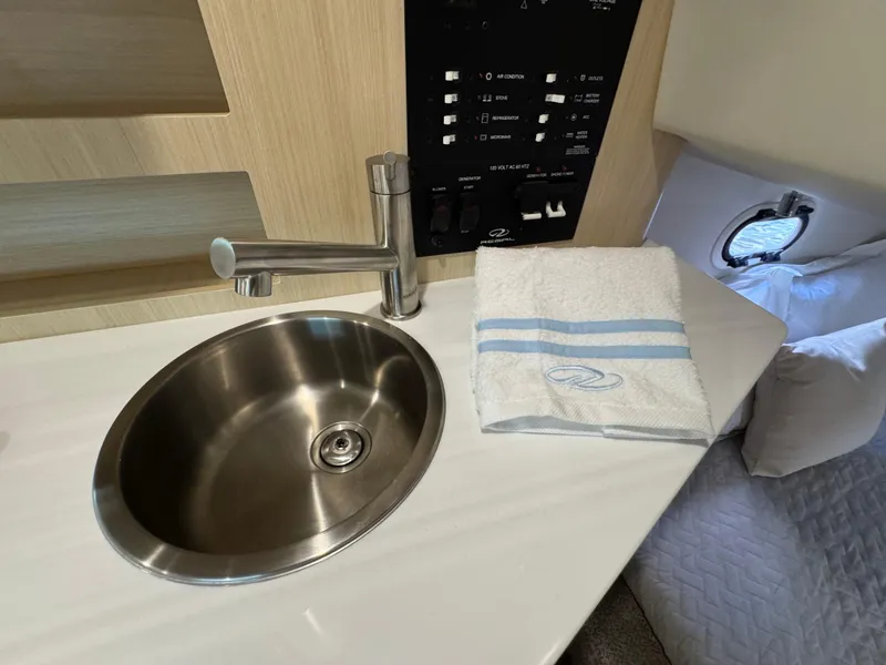 Slide: The Image of 2024 Regal 26 XO boat interior with sink, faucet, and control panel. - 29