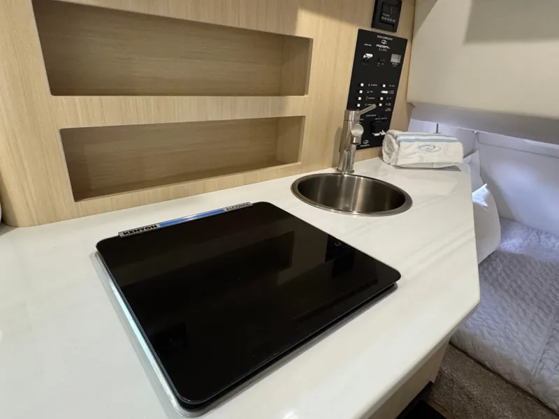 Slide: The Image of 2024 Regal 26 XO cabin interior with sink, control panel, and countertop. - 33