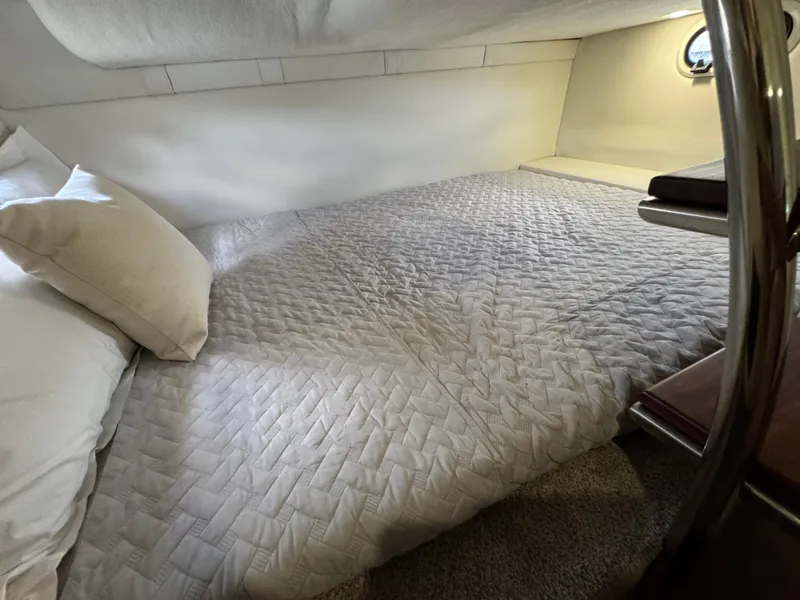 Slide: The Image of 2024 Regal 26 XO cabin interior with cozy bed and soft lighting. - 35