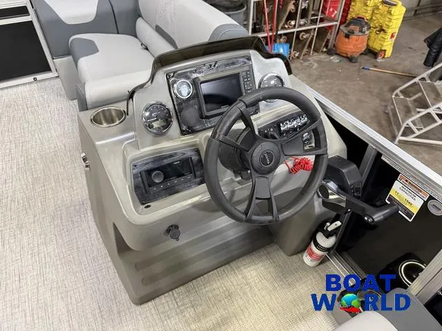Slide: The Image of 2025 Tahoe Geofish 2385 boat console with steering wheel and controls in a showroom. - 14