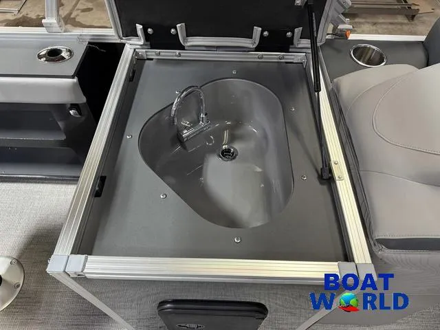 Slide: The Image of 2025 Tahoe Geofish 2385 boat interior with built-in sink and seating, Boat World logo. - 20