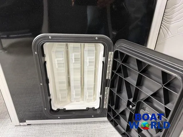 Slide: The Image of Open storage compartment on 2025 Tahoe Geofish 2385 boat, featuring organized interior. - 21