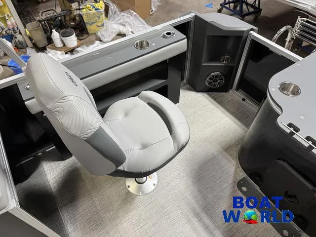 Slide: The Image of 2025 Tahoe Geofish 2385 boat interior with swivel chair and storage compartments. - 27