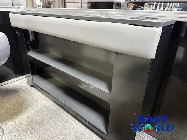 Slide: The Image of 2025 Tahoe Geofish 2385 boat interior with storage shelves and cushioned seating. - 28