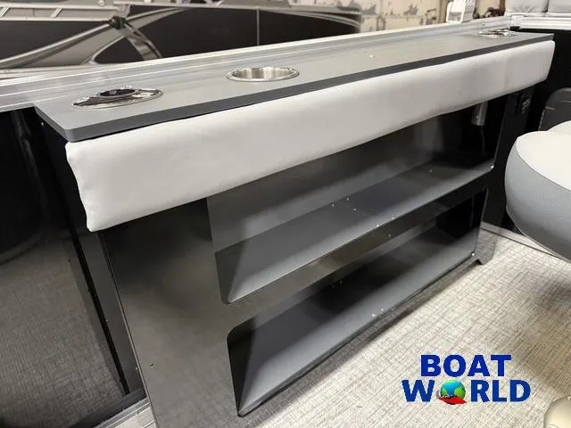 Slide: The Image of 2025 Tahoe Geofish 2385 boat interior with storage shelves and cup holders. - 31