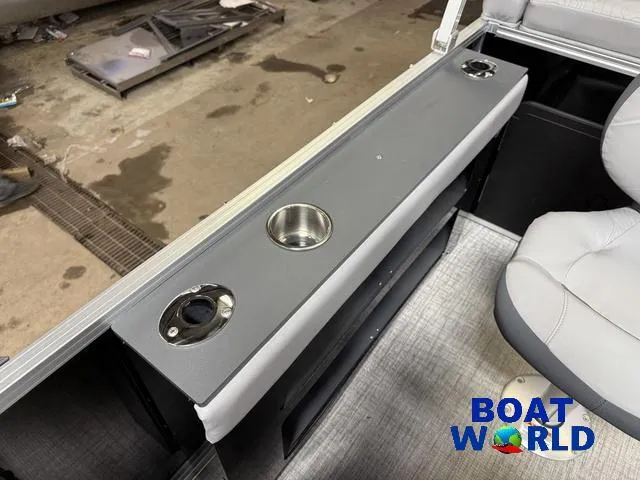 Slide: The Image of 2025 Tahoe Geofish 2385 boat interior with cup holders and seating, branded "Boat World." - 36