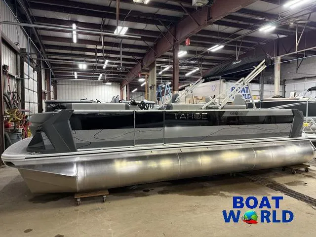 Slide: The Image of 2025 Tahoe Geofish 2385 pontoon boat in a warehouse, featuring Honda 4-Stroke EFI engine. - 49