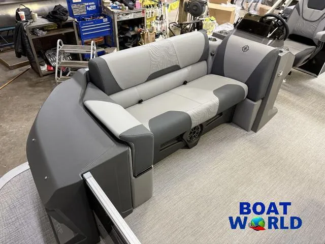 Slide: The Image of 2025 Tahoe Geofish 2385 boat interior with gray seating and steering console. - 9