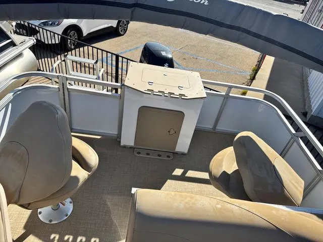 Slide: The Image of Pontoon boat interior with beige seating, Avalon VTX1880QF 2022 model, parked in a lot. - 11