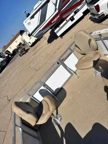 Slide: The Image of 2022 Avalon VTX1880QF boat with beige seats, parked near RVs. - 12