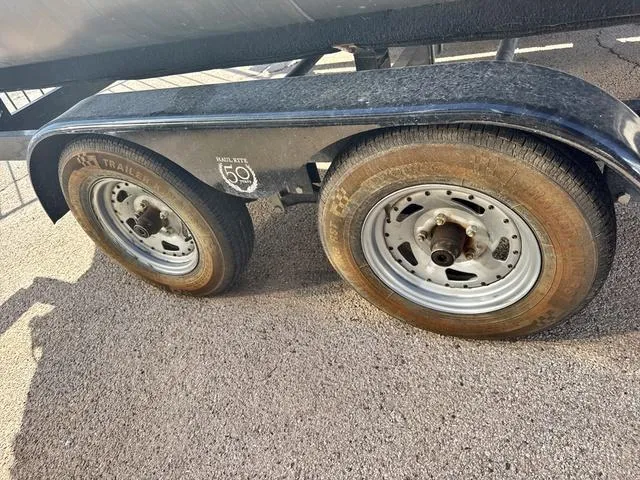 Slide: The Image of Trailer wheels of a 2022 Avalon VTX1880QF on a gravel surface. - 14