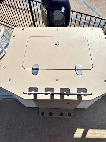 Slide: The Image of 2022 Avalon VTX1880QF boat storage compartment with secure latches and railing. - 9