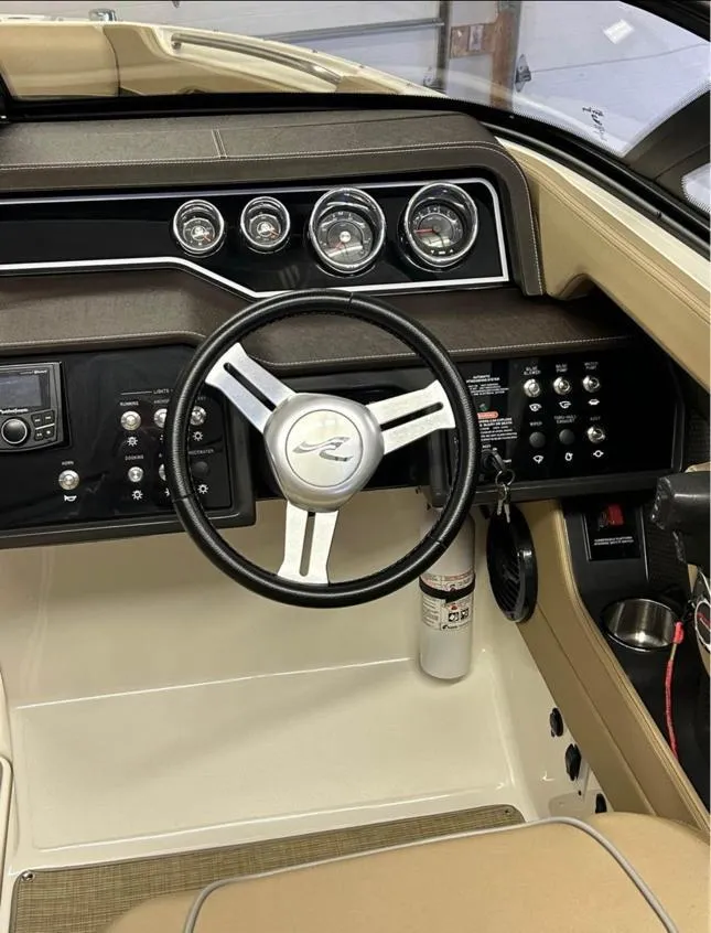 Slide: The Image of 2016 Sea Ray SLX 230 dashboard with steering wheel and control panel. - 3