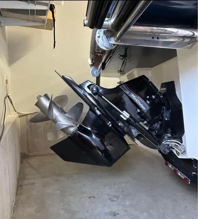 Slide: The Image of 2016 Sea Ray SLX 230 boat with MerCruiser engine and propeller in a garage. - 4