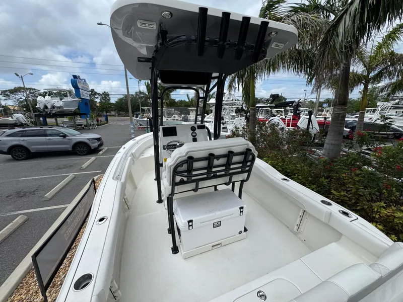 Slide: The Image of 2025 Key West 219 FS boat with T-top, parked in a marina setting. - 10