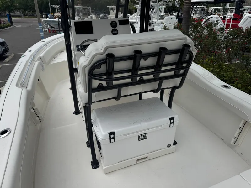 Slide: The Image of 2025 Key West 219 FS boat interior with seating and cooler, docked in a marina. - 12