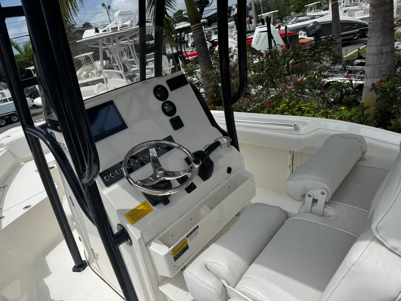Slide: The Image of 2025 Key West 219 FS boat interior with steering console and seating. - 16