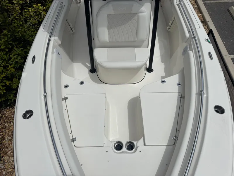 Slide: The Image of 2025 Key West 219 FS boat interior with white seating and storage compartments. - 21