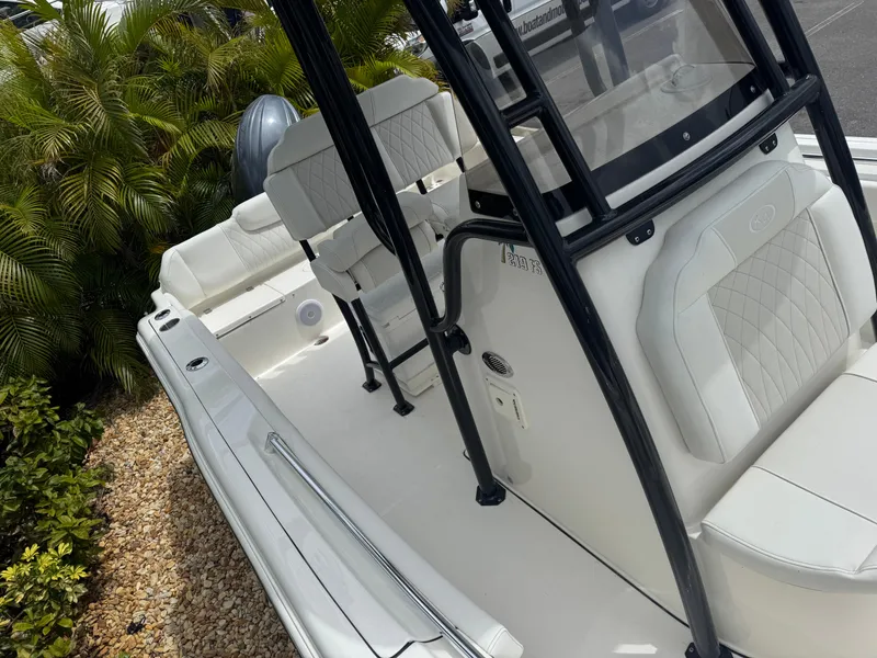 Slide: The Image of 2025 Key West 219 FS boat interior with white seating and sleek design. - 24