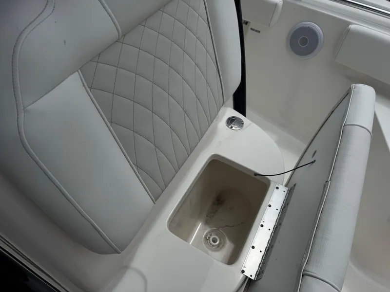 Slide: The Image of 2025 Key West 219 FS boat seat with storage compartment and speaker. - 25