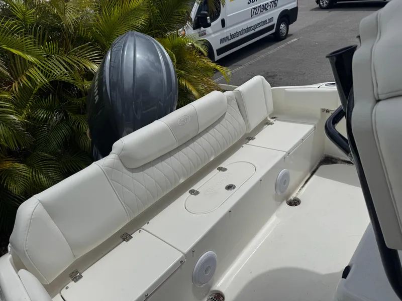 Slide: The Image of 2025 Key West 219 FS boat interior with white seating and outboard motor. - 29