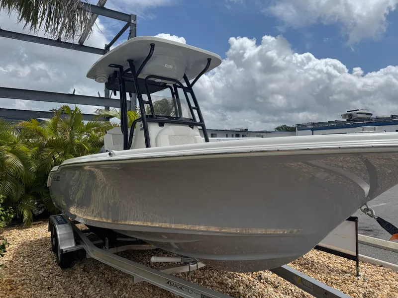 Slide: The Image of 2025 Key West 219 FS boat on trailer under cloudy sky. - 3