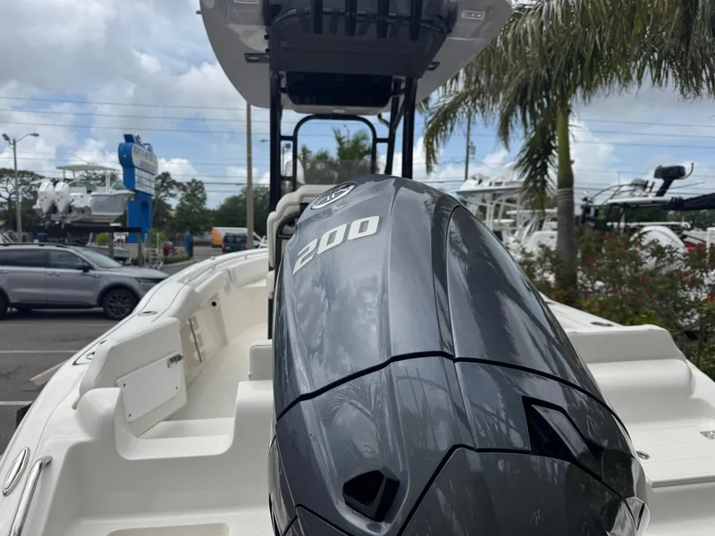 Slide: The Image of 2025 Key West 219 FS boat with powerful 200 HP engine, parked outdoors. - 6
