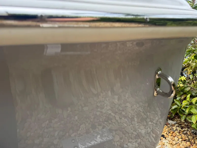 Slide: The Image of 2025 Key West 219 FS boat detail with chrome hardware and reflective surface. - 8