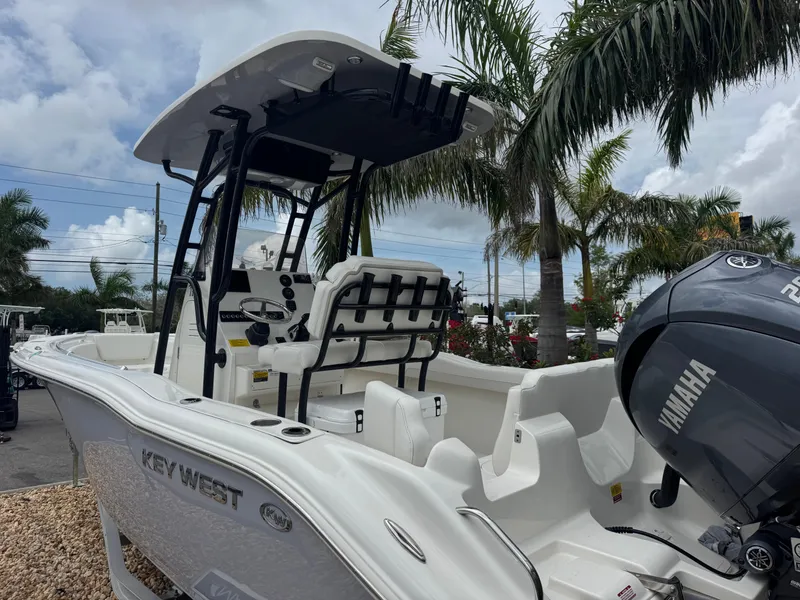 Slide: The Image of 2025 Key West 219 FS boat with Yamaha engine, parked near palm trees. - 9