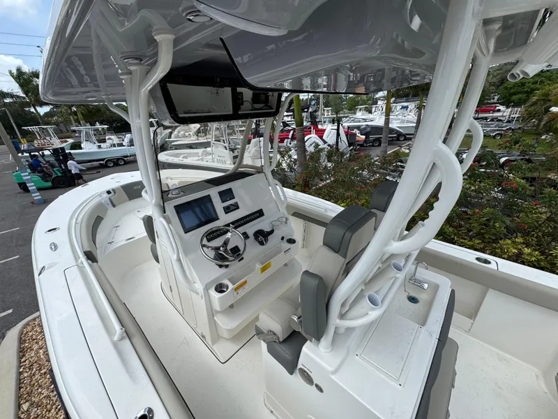 Slide: The Image of 2025 Key West 260 boat interior with modern helm and seating, displayed outdoors. - 11