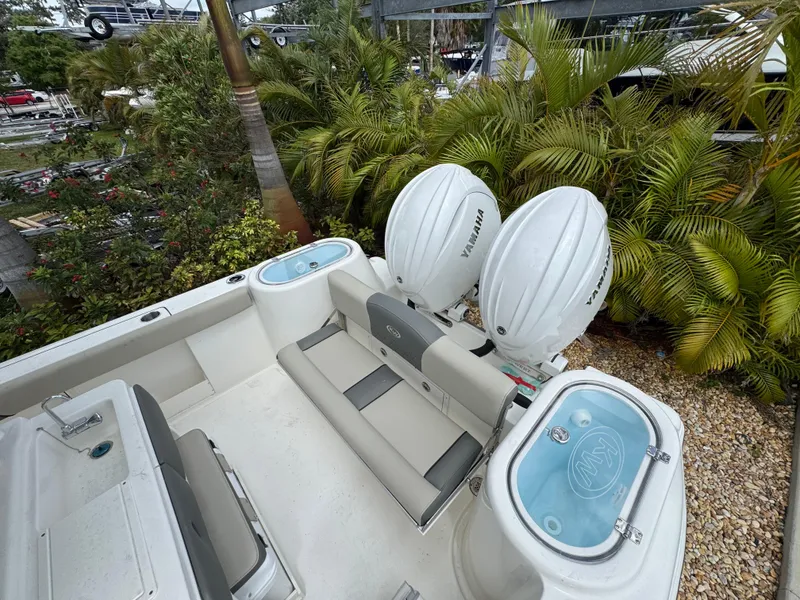 Slide: The Image of 2025 Key West 260 boat with twin outboard engines, surrounded by lush greenery. - 12