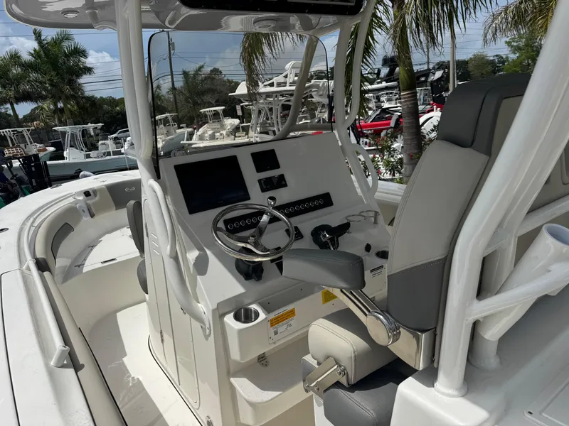 Slide: The Image of 2025 Key West 260 boat interior with steering console, modern controls, and seating. - 15
