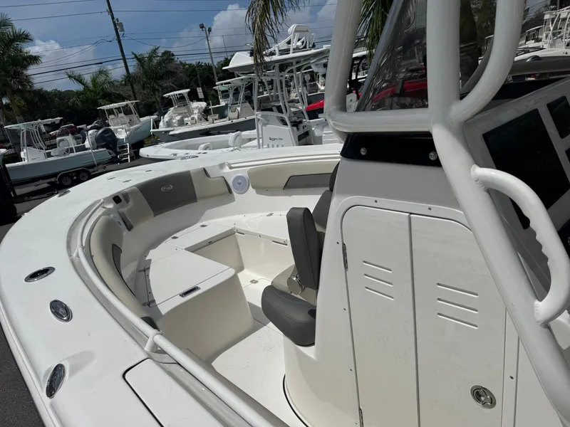 Slide: The Image of 2025 Key West 260 boat interior with seating and storage, displayed outdoors. - 17