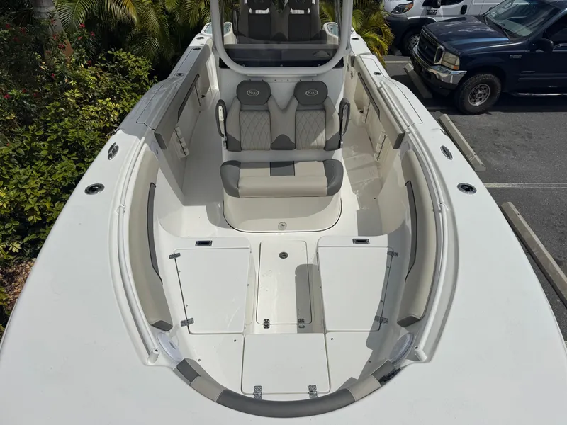 Slide: The Image of 2025 Key West 260 boat interior with seating and storage, parked outdoors. - 20