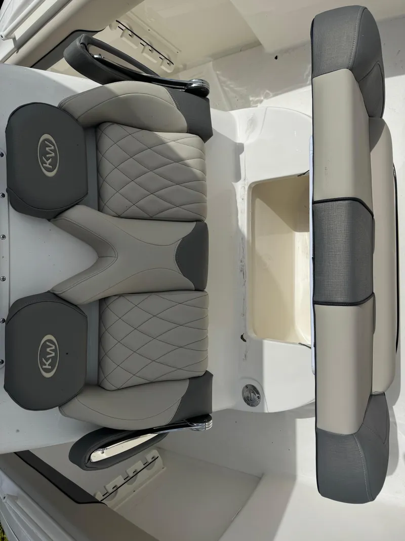 Slide: The Image of 2025 Key West 260 boat seating with gray and black upholstery. - 26
