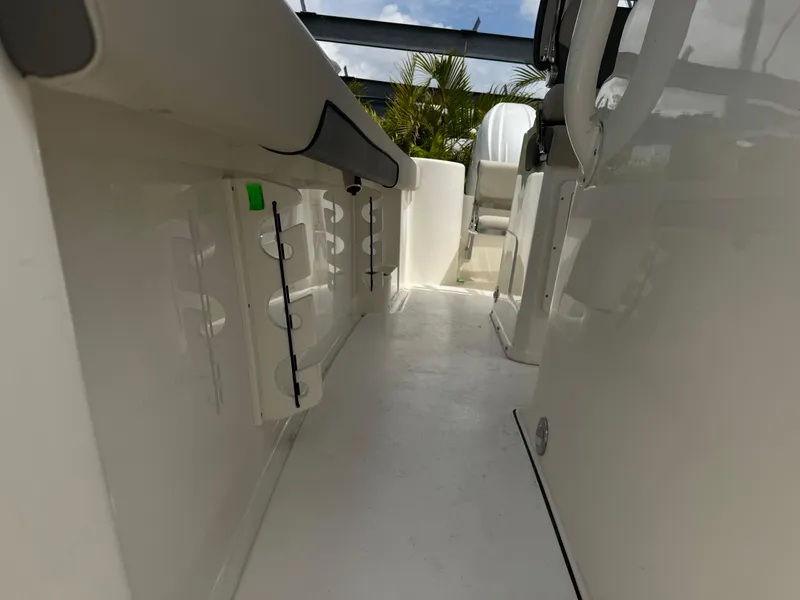 Slide: The Image of 2025 Key West 260 boat interior, featuring sleek white design and modern seating arrangement. - 27
