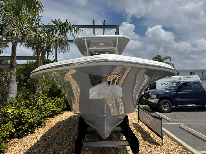 Slide: The Image of 2025 Key West 260 boat displayed outdoors, surrounded by palm trees and parked vehicles. - 3