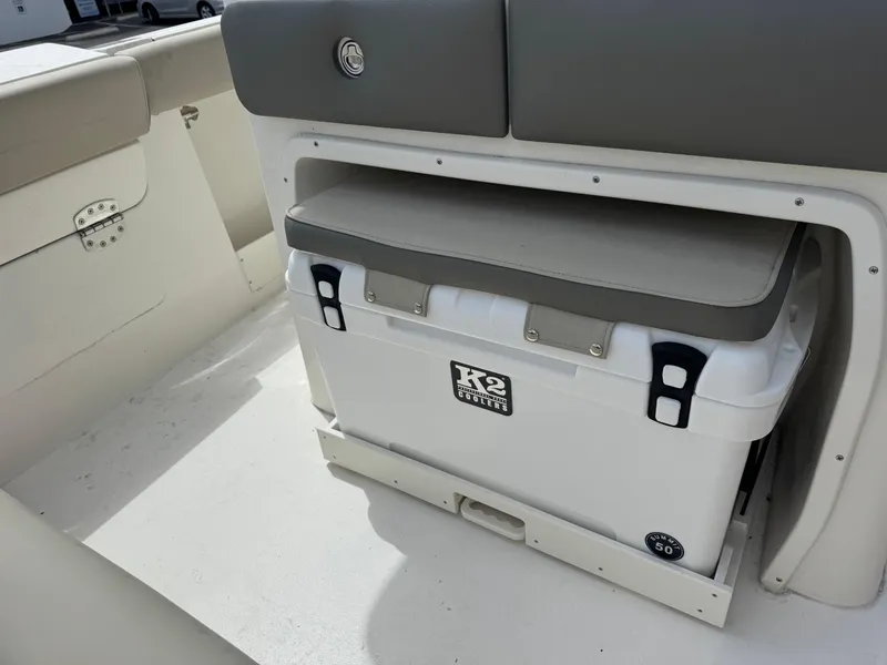 Slide: The Image of 2025 Key West 260 boat interior with cooler storage under cushioned seat. - 34