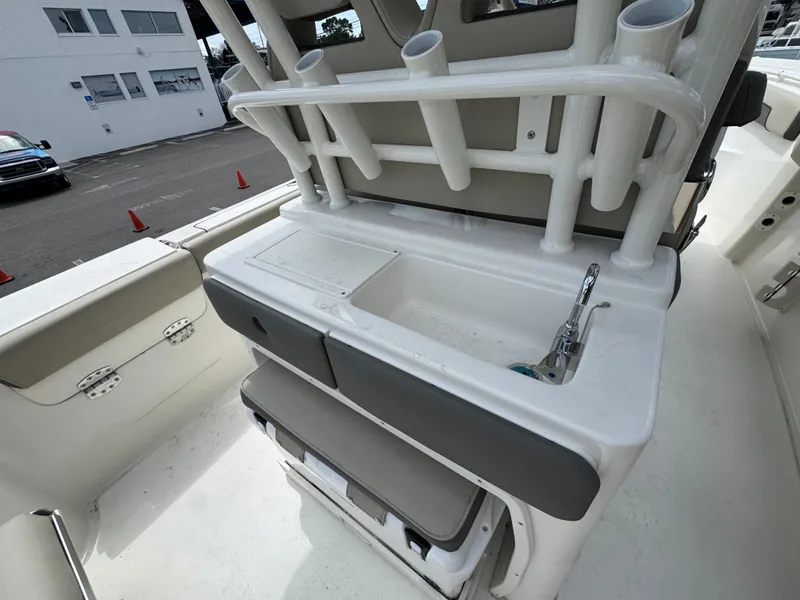 Slide: The Image of Key West 260 boat interior with sink and rod holders, 2025 model. - 36