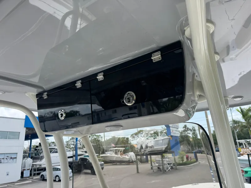 Slide: The Image of 2025 Key West 260 boat storage compartment, sleek design, outdoor marina setting. - 39