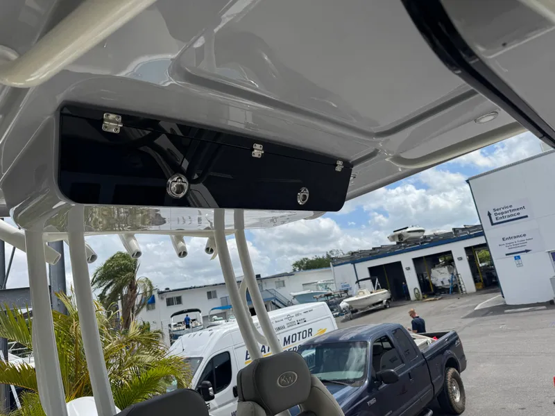 Slide: The Image of 2025 Key West 260 boat interior with overhead storage, parked in a marina. - 40