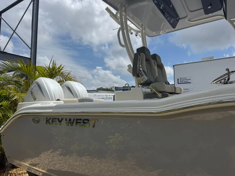 Slide: The Image of 2025 Key West 260 boat with dual engines, under a partly cloudy sky. - 5