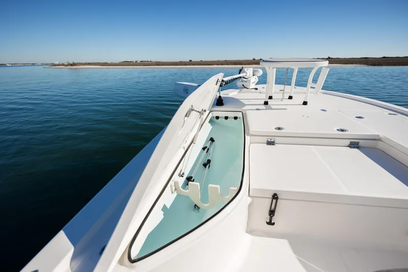 Slide: The Image of 2024 Sea Born FX22 Bay boat on calm water, showcasing deck storage. - 11