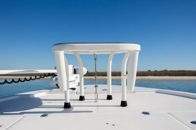 Slide: The Image of 2024 Sea Born FX22 Bay boat deck with a white seat and clear blue sky. - 15